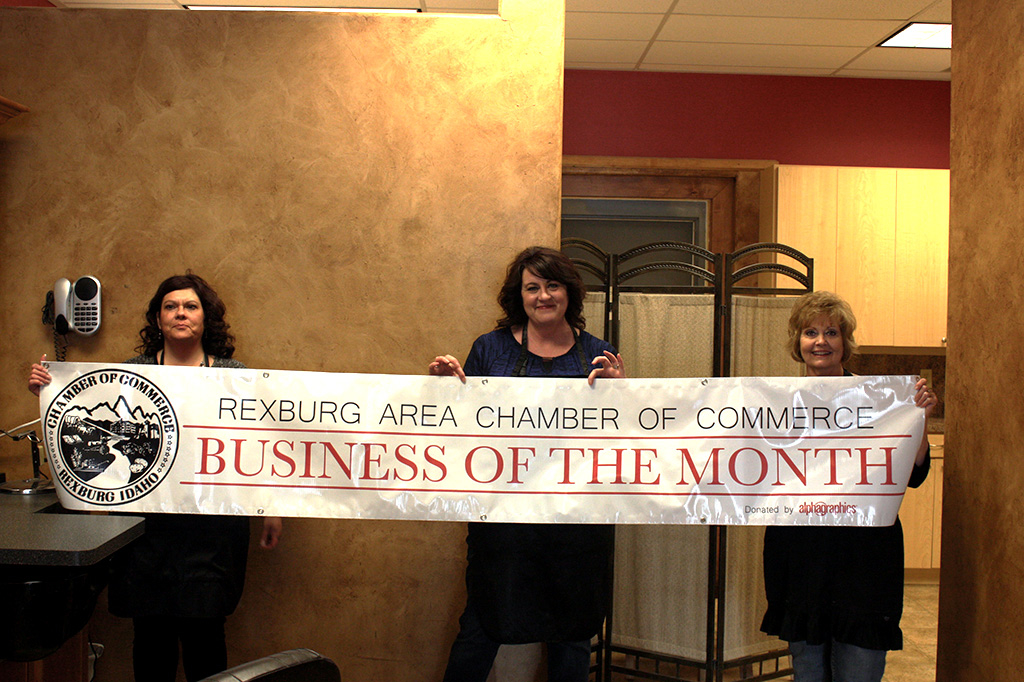 B'Dazzled Hair & Nails team holding the business of the month banner.