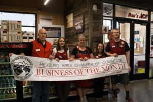 Dan's Ace Hardware employees holding business of the month banner.